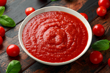 Homemade tomato Passata in white bowl on wooden table