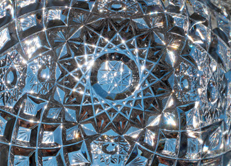 Circle glowing crystal glass, abstract background. Close up detail of vintage vase design. Beautiful macro view of glittering light refraction in cut glass facets.