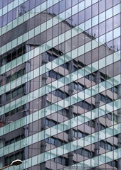 Obraz premium Building is reflected in a glazed modern building office center. Europe, Bulgaria, Sofia