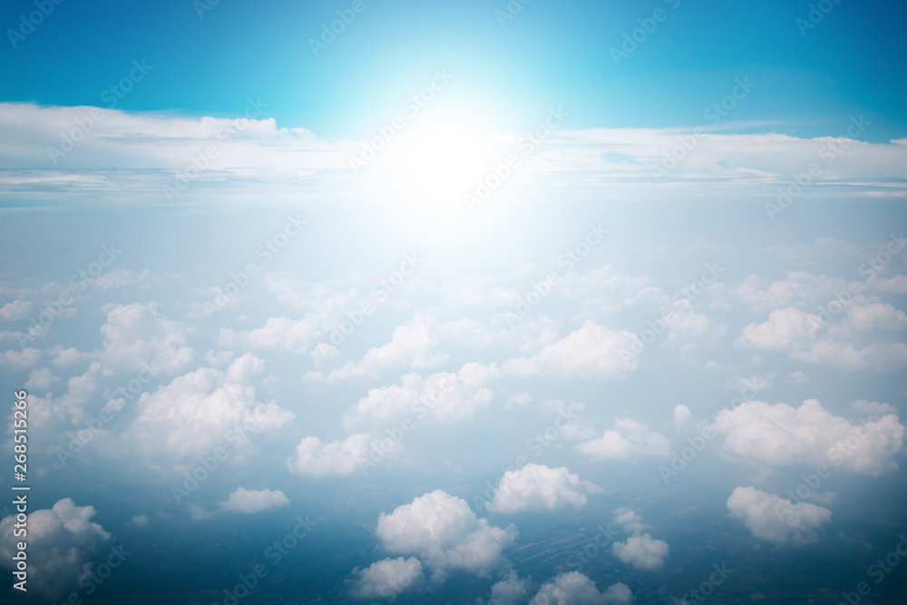 Wall mural view of the sky clouds above the clouds from airplane window with sun light retro color filter