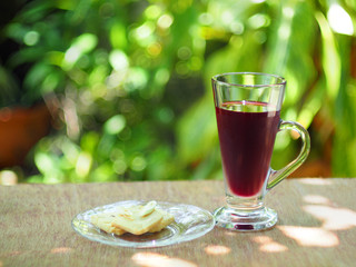 berry juice with lemongrass cookie on green background, healthy concept