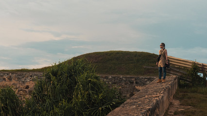 Traveller walking on a castle wall in Galle, Sri Lanka