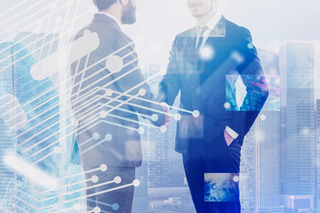 Two business leaders handshake, telecommunication