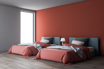 Red and white bedroom interior with two beds