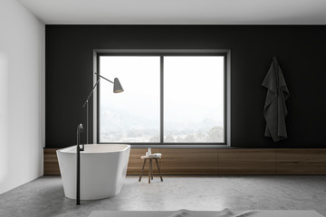 White and gray bathroom with tub and window