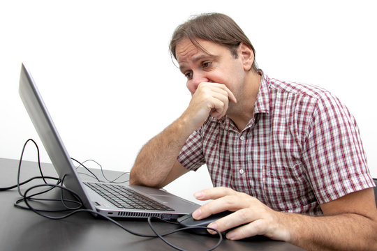 Unhappy user looking at display of notebook at office. A sadness man looking at laptop. System error on computer.