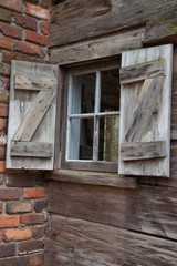 Obraz na płótnie Canvas Log cabin and wooden shutters