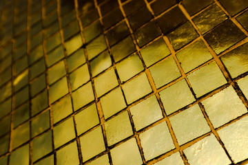 Beautiful closeup textures abstract tiles and gold color glass wall background and art wallpaper