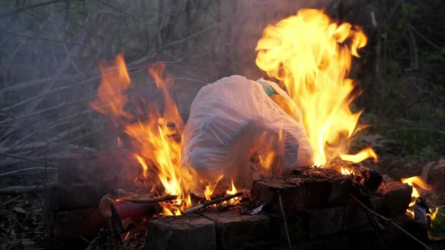 flame fire and smoke burning garbage waste of plastic to air pollution.