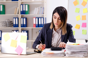 Young female employee in conflicting priorities concept 