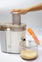Modern electric juicer  various fruit and glass of freshly made juice  healthy lifestyle concept