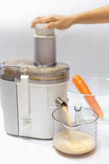 Modern electric juicer  various fruit and glass of freshly made juice  healthy lifestyle concept
