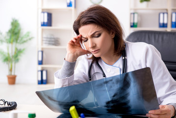 Aged female doctor working in the clinic 