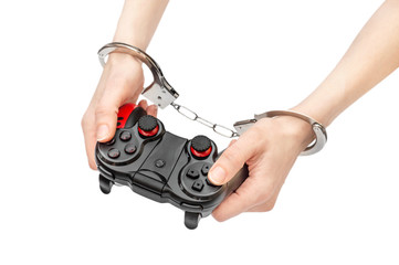 Woman hands in handcuffs holding gamepad. isolated on white. Game dependency.