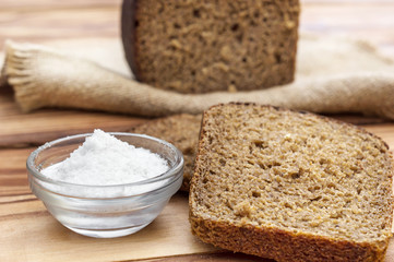 Rye bread with salt on the table. Close up.