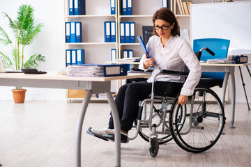 Female employee in wheel-chair at the office  