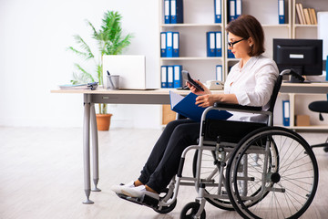 Female employee in wheel-chair at the office  