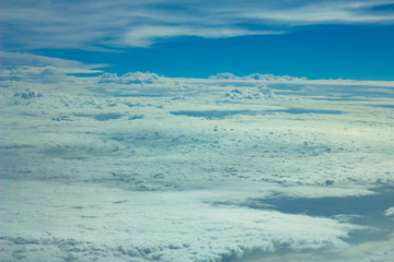 Naklejka na ściany i meble white valley of clouds under blue sky aerial view