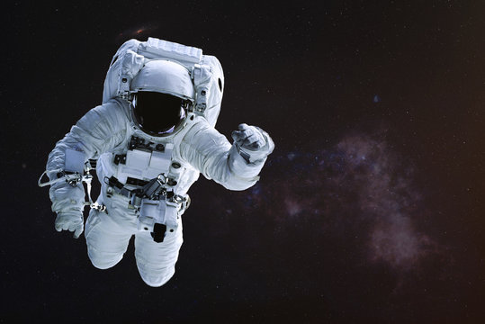 Astronaut in outer space. Science fiction wallpaper. Elements of this image were furnished by NASA.