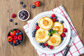 Tasty fluffy pancakes with berries