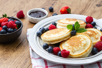 Tasty fluffy pancakes with berries