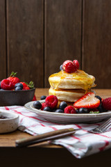 Tasty fluffy pancakes with berries