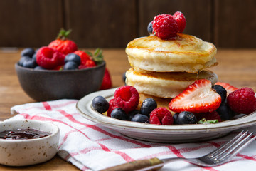 Tasty fluffy pancakes with berries