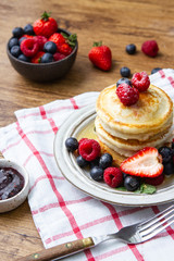 Tasty fluffy pancakes with berries