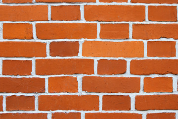 Texture red brick wall. New brown brick with white cement closeup.