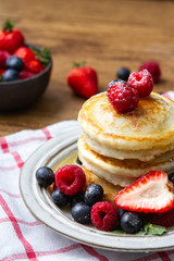 Tasty fluffy pancakes with berries