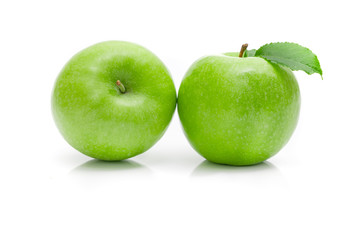 Ripe green apple with leaf on a white background .