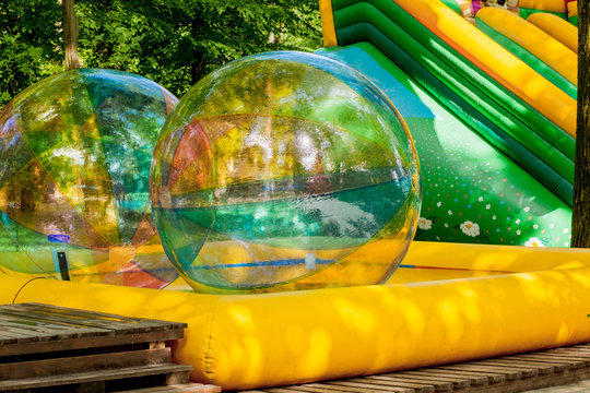 Aqua Zorbing. Colorful Water Walking Balls. Water Activity For Kids. Children Playing Together And Having Fun Inside Large Inflatable Sphere In A Pool