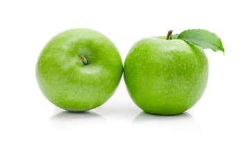 Ripe green apple with leaf on a white background .