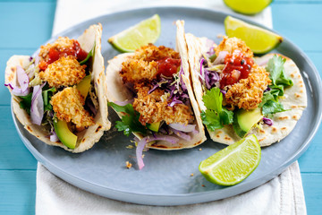 Tacos with chicken in panko breadcrumbs, avocado, red and white cabbage coleslaw