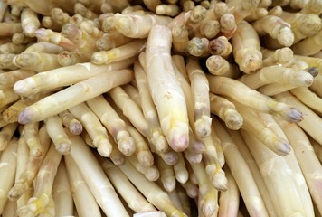 Many raw white asparagus on a rural  market shelf. Food background 