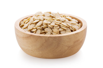 Pumpkin seeds in wood bowl on white background