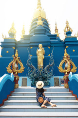 A woman is traveling at Blue temple in Chiangrai.