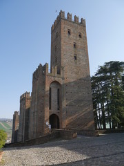 Fototapeta na wymiar Visconti Castle in Castell'Arquato. Visconti Castle was the seat of the Visconti garrison and has a quadrangular plan with four towers, a mastio and a ditch with two entrances. 