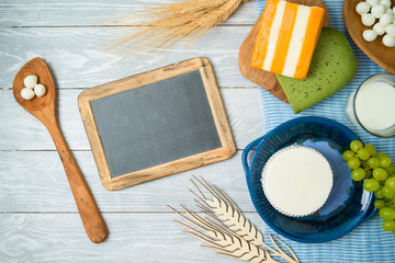 Milk and dairy products on wooden background.