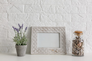 Mock up white frame and aloe vera plant on book shelf or desk. White colors.