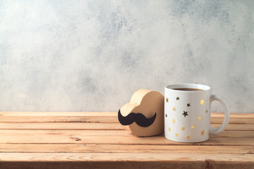 Happy Father's day concept with coffee mug and gift box over wooden background