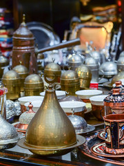 Fototapeta na wymiar Turkish coffee sets and Jezve pot on the bazaar counter. Typical Turkish souvenirs.
