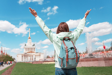 Happy girl travels to Moscow and enjoys the stunning view of the Palace of VDNH