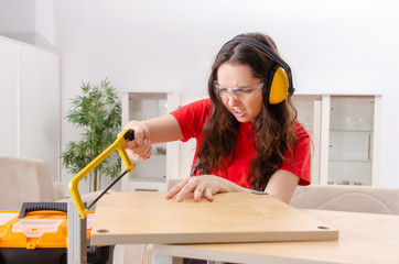 Female contractor repairing furniture at home 