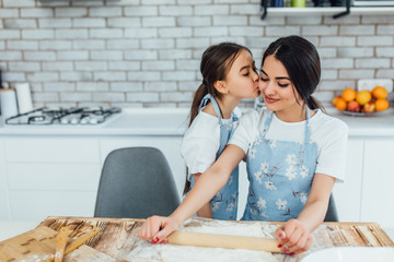 Cook at home. Kid kissing girl. Home cooking!