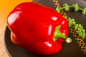 a freshest red paprika, bell pepper in ceramic plate