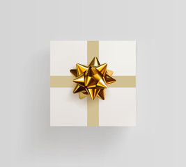 Decorative white gift box with realistic golden bow