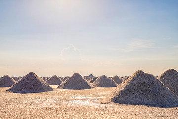 Fototapeta na wymiar Heap of sea salt in a field prepared for harvest. Naklua Mass of salt in salt seaside farm
