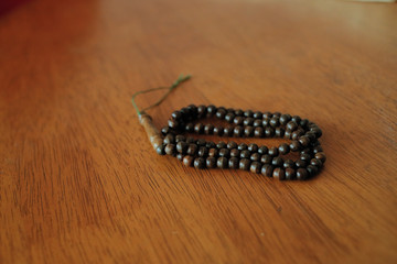 Islamic tasbih bead on wooden table background, shot from a 45 degree angle