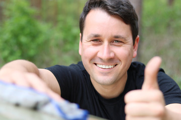 thumbs up man is cleaing a car